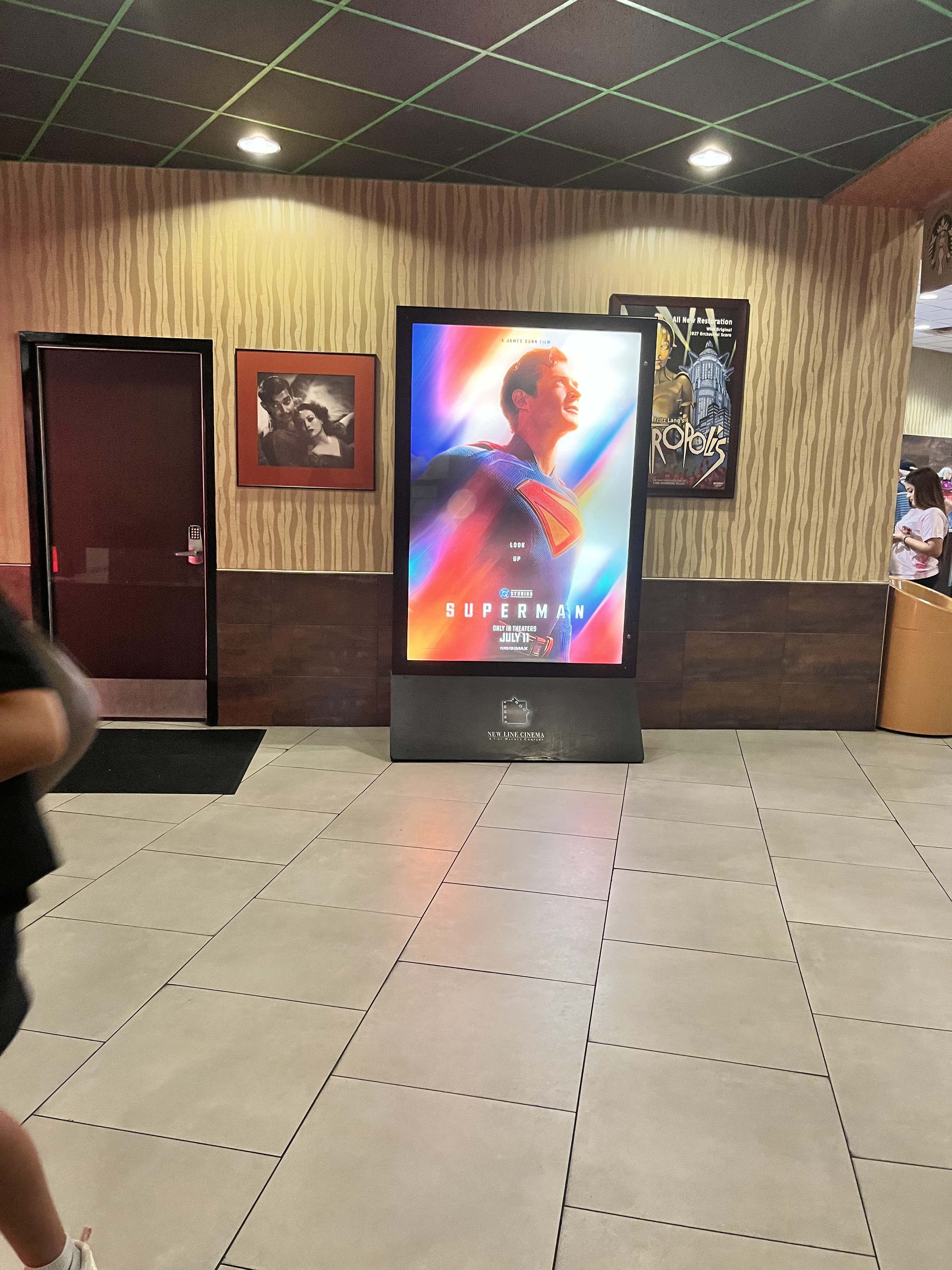 a poster of the superman movie in a movie theatre