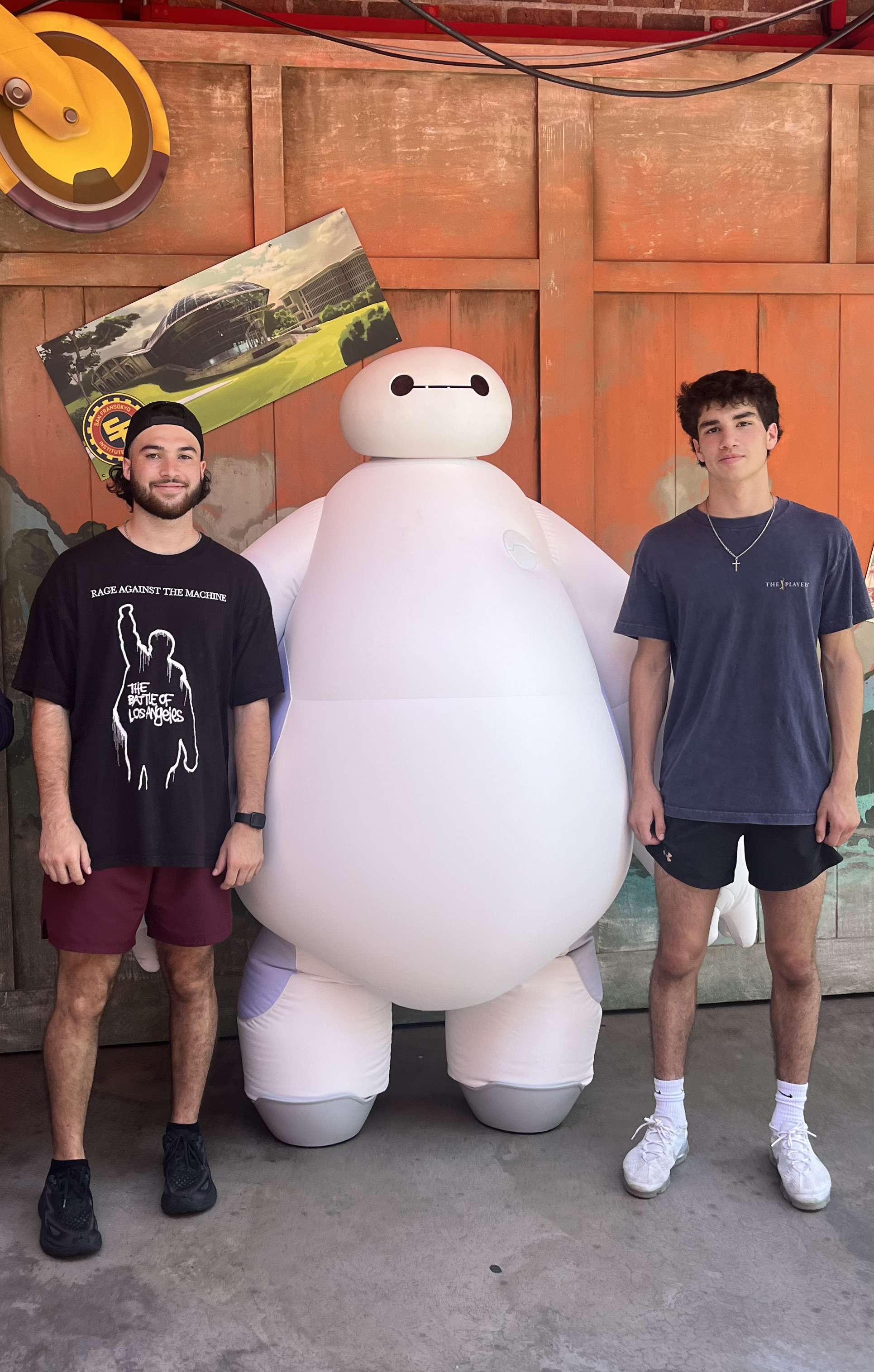 Me and my brother standing next to baymax
